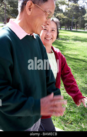 Senior Asian Couple Walking Through Park Together Stock Photo - Alamy