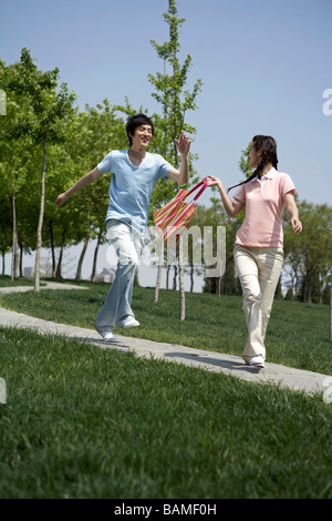 Young Couple Walking In The Park Stock Photo