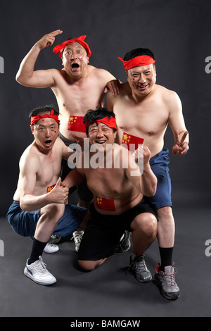 Portrait Of Fans With Flags Painted On Their Stomachs Stock Photo