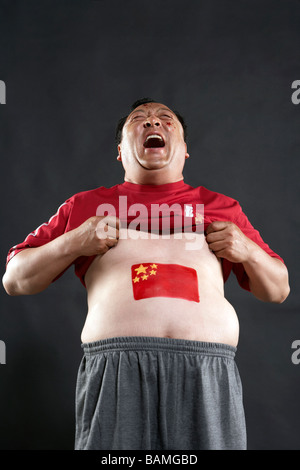 Man With Flag Painted On His Stomach Stock Photo