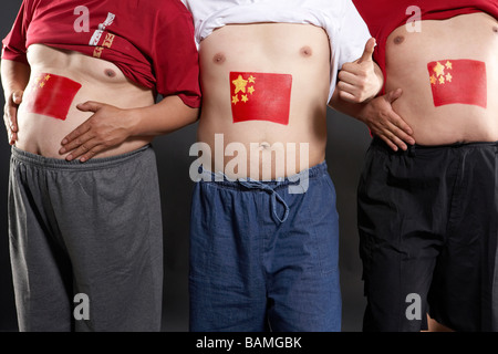 Close-Up Of Men With Flags Painted On Their Stomachs Stock Photo