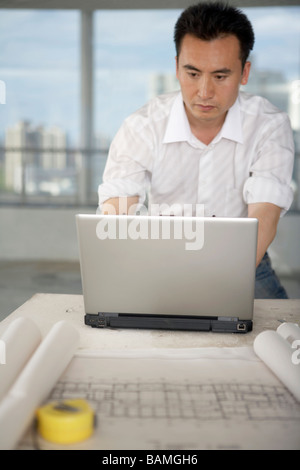 Architect Looking At Laptop Stock Photo