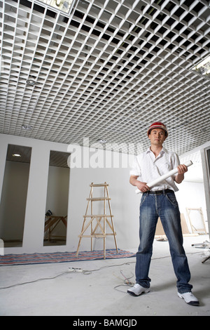 Man In Construction Site Wearing A Hard Hat Stock Photo