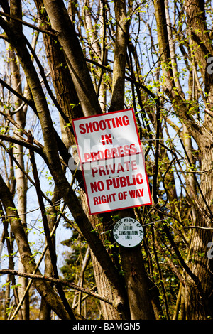 Warning sign on a tree. Shooting in progress. Private, no public right of way. Stock Photo