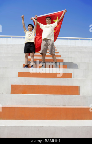 Father And Son Cheering With Chinese Flag Stock Photo