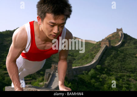 Gymnast Doing Push Up On The Great Wall Of China Stock Photo