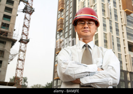 Construction Contractor Standing On Building Site Stock Photo