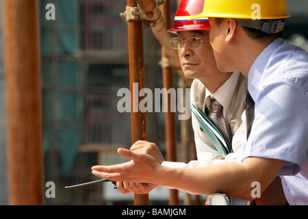 Construction Contractors Talking To Each Other Stock Photo