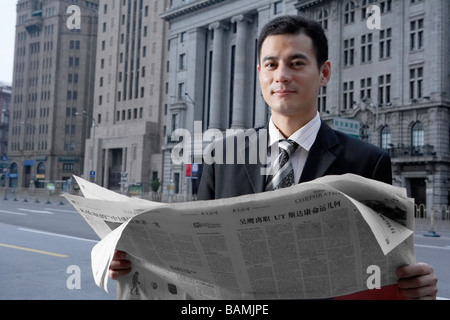 Portrait Of Businessman With Newspaper Stock Photo