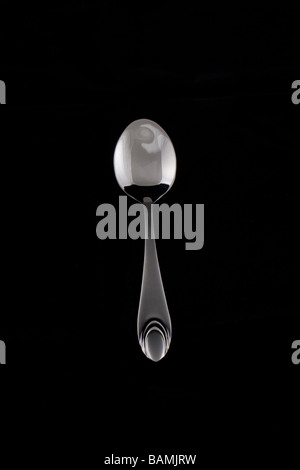 Metal, shiny tea spoon isolated on black background Stock Photo