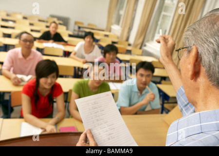 Teacher Lecturing Students In A Class Room Stock Photo