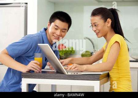 Young Couple In The Kitchen Stock Photo