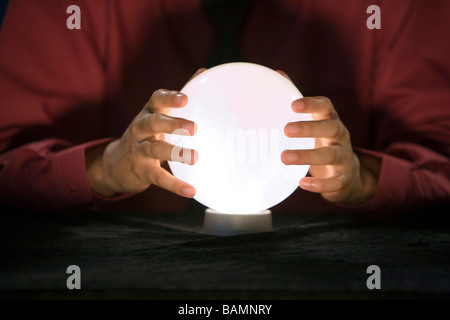 Businessman Holding Crystal Ball Stock Photo