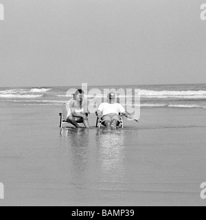 A man and a woman relaxing on New Jersey beach, near New Jersey, USA Stock Photo