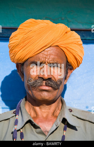 Man wearing a colourful saffron turban at Osian Camel Camp, Osian, Rajasthan, India Stock Photo