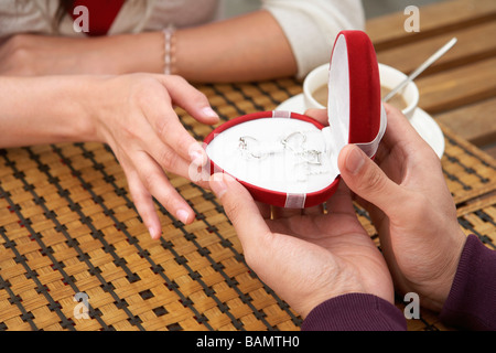 Young Man Giving Necklace To Girlfriend Stock Photo