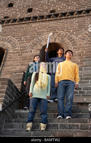 Two Young Couples Perform The Passing Of The Torch Ceremony At The UNESCO World Heritage Site Stock Photo