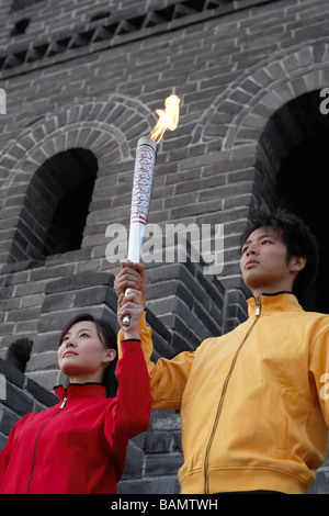 Two Young Couples Perform The Passing Of The Torch Ceremony At The UNESCO World Heritage Site Stock Photo