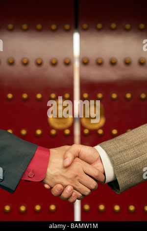 Two Businessmen Shake Hands Outside The Forbidden City Stock Photo