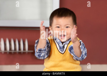 Young boy clapping happily Stock Photo