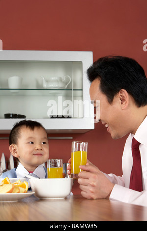 Father and son having breakfast together Stock Photo