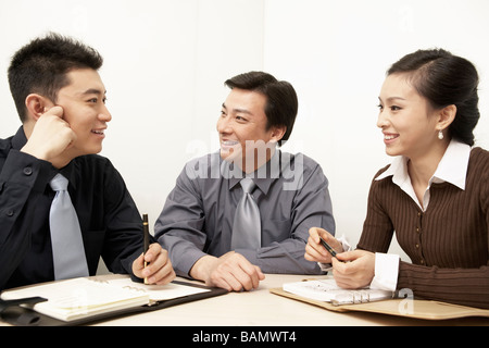 Businesspeople Having A Discussion In A Board Room Stock Photo