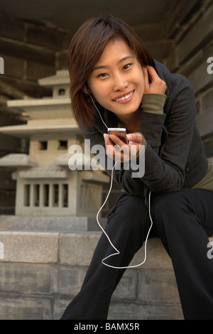 Young Woman In Sportswear Listening To Headphones Stock Photo