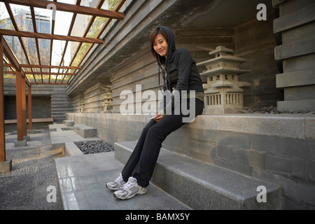 Young Woman In Sportswear Listening To Headphones Stock Photo