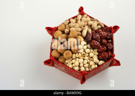 Dried fruits, nuts and legumes in a red star-shaped dish Stock Photo