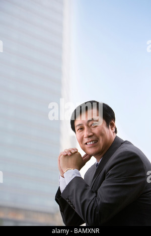 Outdoors portrait Asian 40s mature businessman smiling happy in city in ...