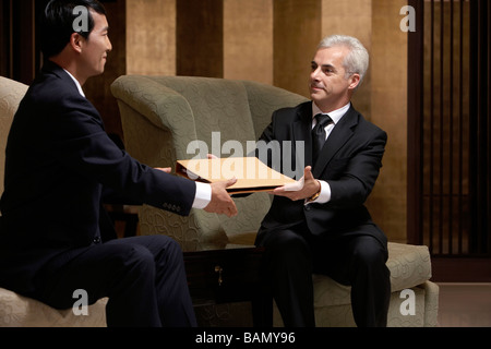 Two business leaders discuss cooperation at an exclusive business club Stock Photo