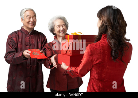 A daughter exchanging gifts with her parents on Chinese New Year Stock Photo