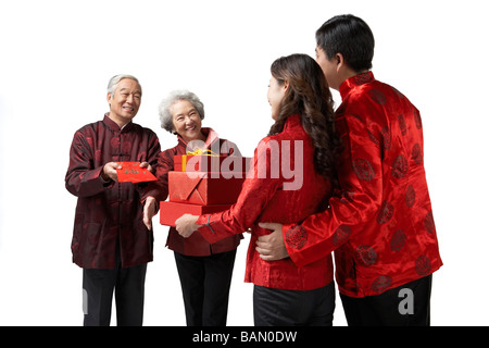 A daughter and her husband exchanging gifts with her parents on Chinese New Year Stock Photo