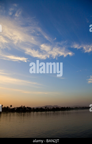 Sunst over the river Nile looking towards Valley of the Kings Luxor Egypt Africa Stock Photo