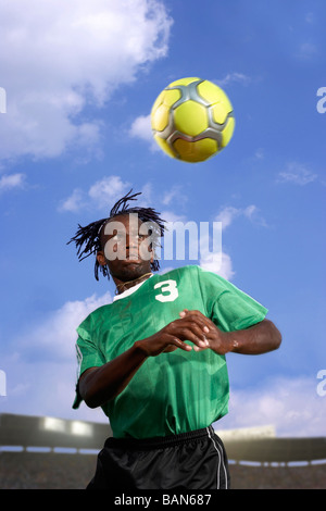 Male soccer player headering the ball Stock Photo