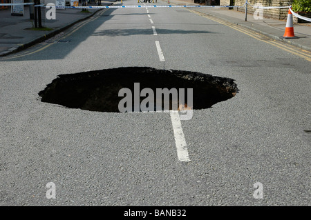 hole in road appeared in didsbury, manchester Stock Photo