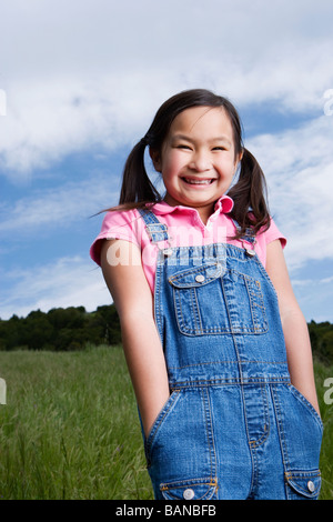 Young Asian girl smiling outdoors