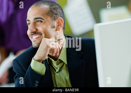 Middle Eastern businessman sitting at desk Stock Photo