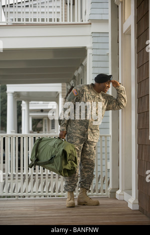 African soldier standing on front stoop Stock Photo