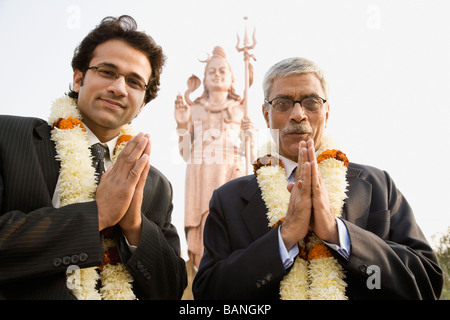 Indian businessmen wearing floral necklaces at tourist attraction Stock Photo