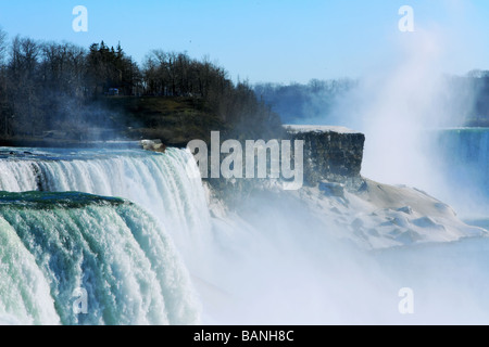 Niagara Falls with mighty pouring water and rising mist viewed from the Niagara Falls State Park in USA Stock Photo
