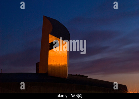 The Imperial War Museum tower lit up at night by sunset, Salford Quays, Manchester, England, UK Stock Photo