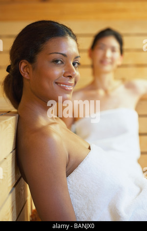 Sauna two women relaxing sweating covered towel Stock Photo - Alamy