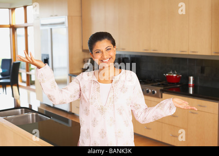 Indian woman standing in kitchen Stock Photo