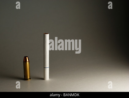 A bullet and a Cigarette standing up Stock Photo