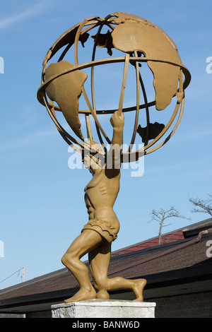 Atlas holding the globe.The statue of Globe Atlas athletick Sculpture of Atlas carrying a globe in side metal figure of man close up of nobody  hi-res Stock Photo
