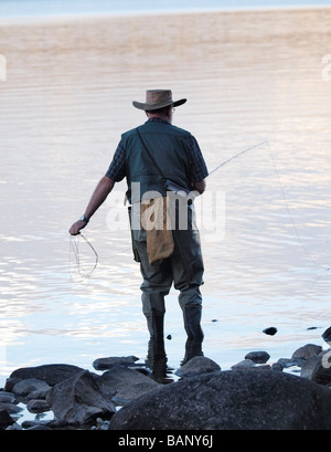 OLDER LONE MAN FLY FISHERMAN FISHING ON LAKE ST CLAIR TASMANIA AUSTRALIA Stock Photo