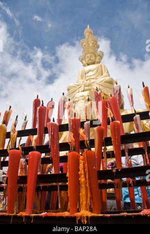 Tribute Candles burning in front of the Golden Buddha in the Summit of the Mount Emei Shan National Park, Sichuan, China 2008 Stock Photo