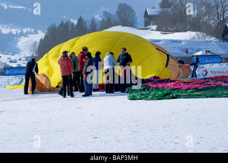 Ground crew laying out and inflating a hot air balloon; 2009 Chateau d'Oex balloon festival, Switzerland, Europe Stock Photo