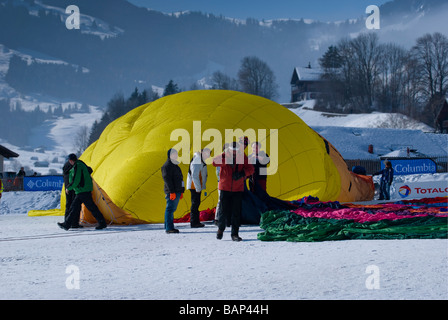 Ground crew laying out and inflating a hot air balloon; 2009 Chateau d'Oex balloon festival, Switzerland, Europe. Charles Lupica Stock Photo